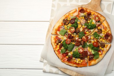 Photo of Delicious vegetarian pizza with mushrooms, vegetables and parsley on white wooden table, top view. Space for text