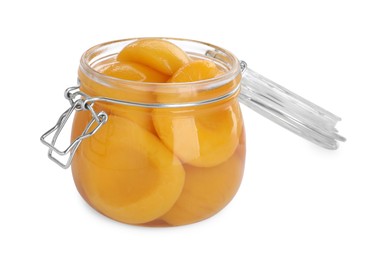 Photo of Glass jar with canned peach halves isolated on white