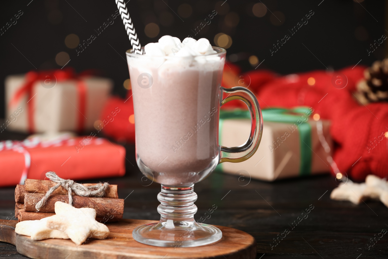Photo of Delicious cocoa drink with marshmallows served on black table