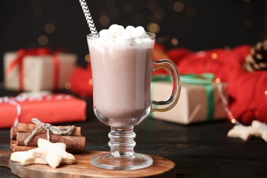 Delicious cocoa drink with marshmallows served on black table