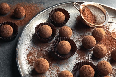 Photo of Plate with tasty chocolate truffles on table