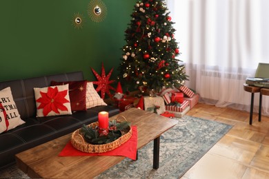 Cozy living room with Christmas tree and festive decor. Interior design