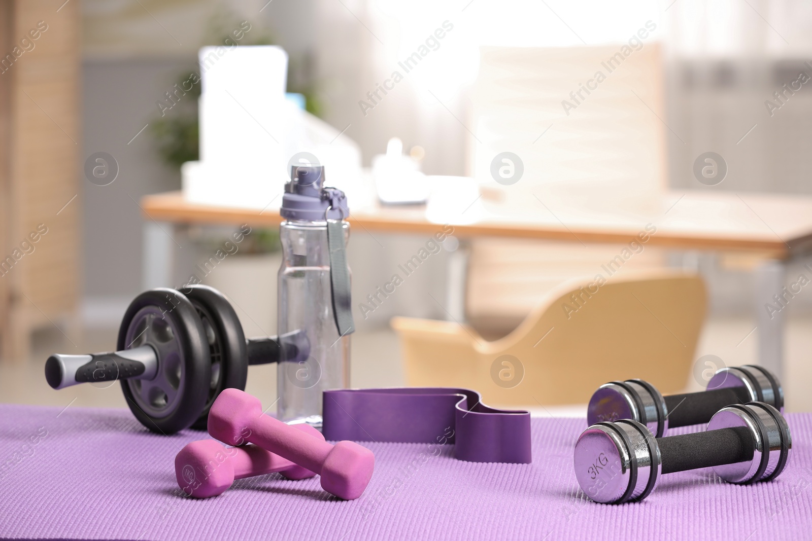 Photo of Many different sports equipment on mat indoors