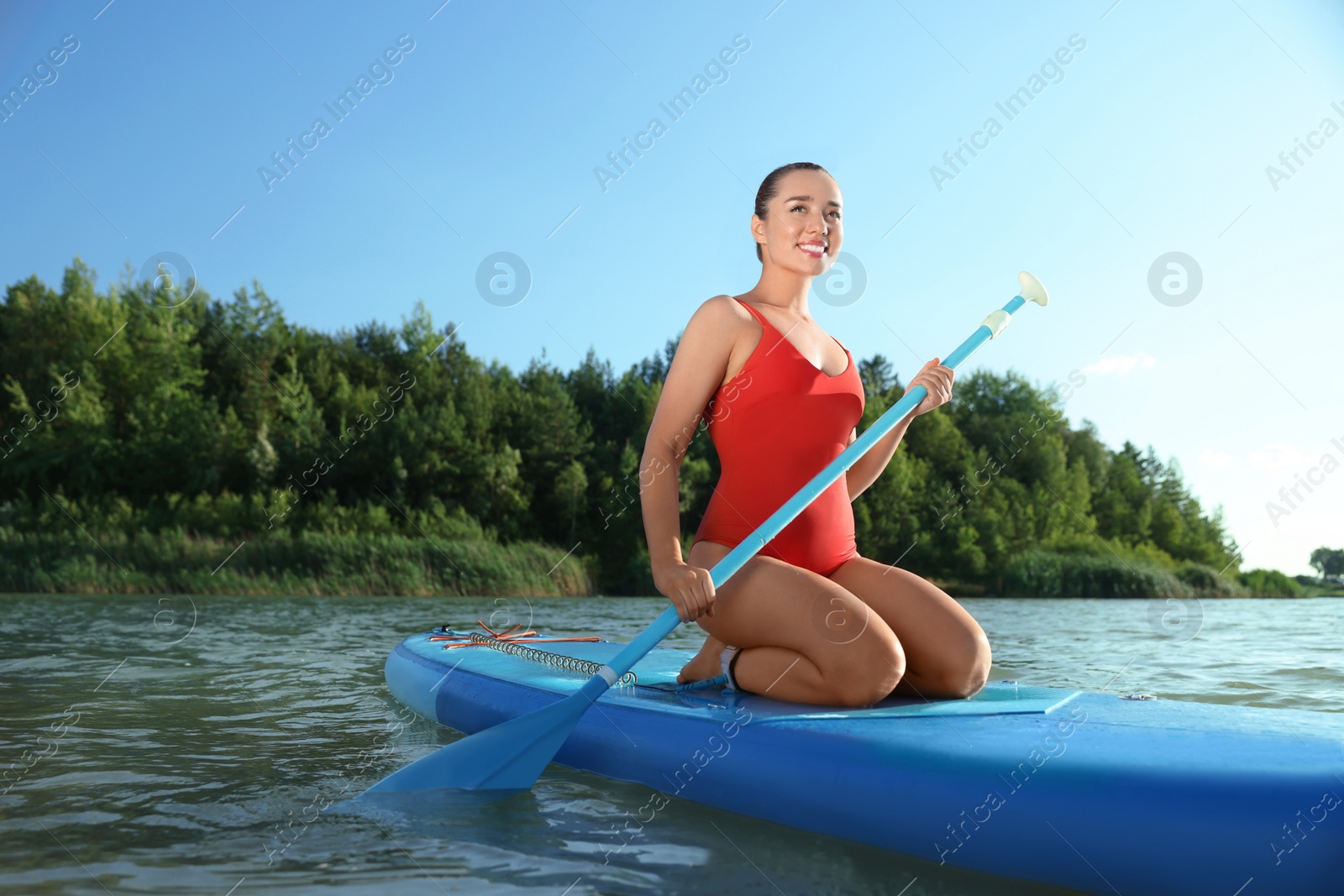 Photo of Woman paddle boarding on SUP board in river