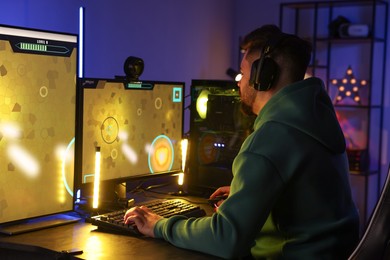 Man playing video games on computer at table indoors