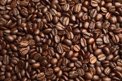 Roasted coffee beans as background, top view