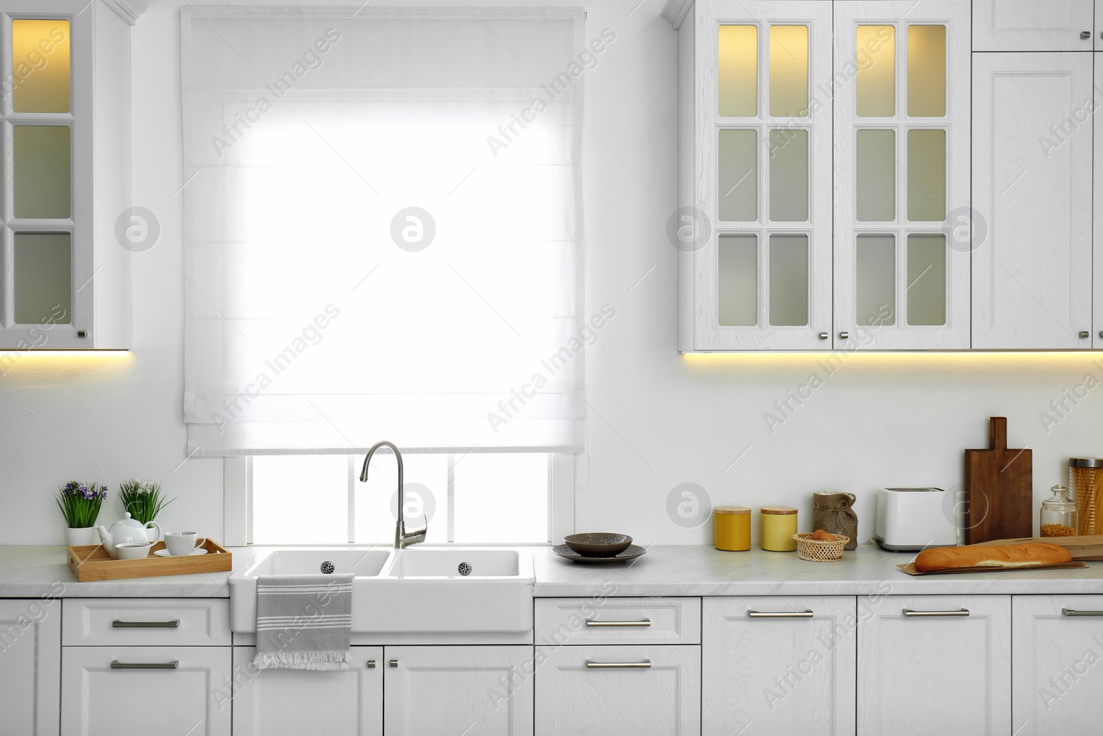 Photo of Modern kitchen interior with stylish white furniture