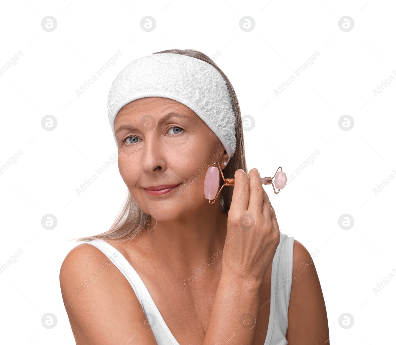 Photo of Woman massaging her face with rose quartz roller isolated on white