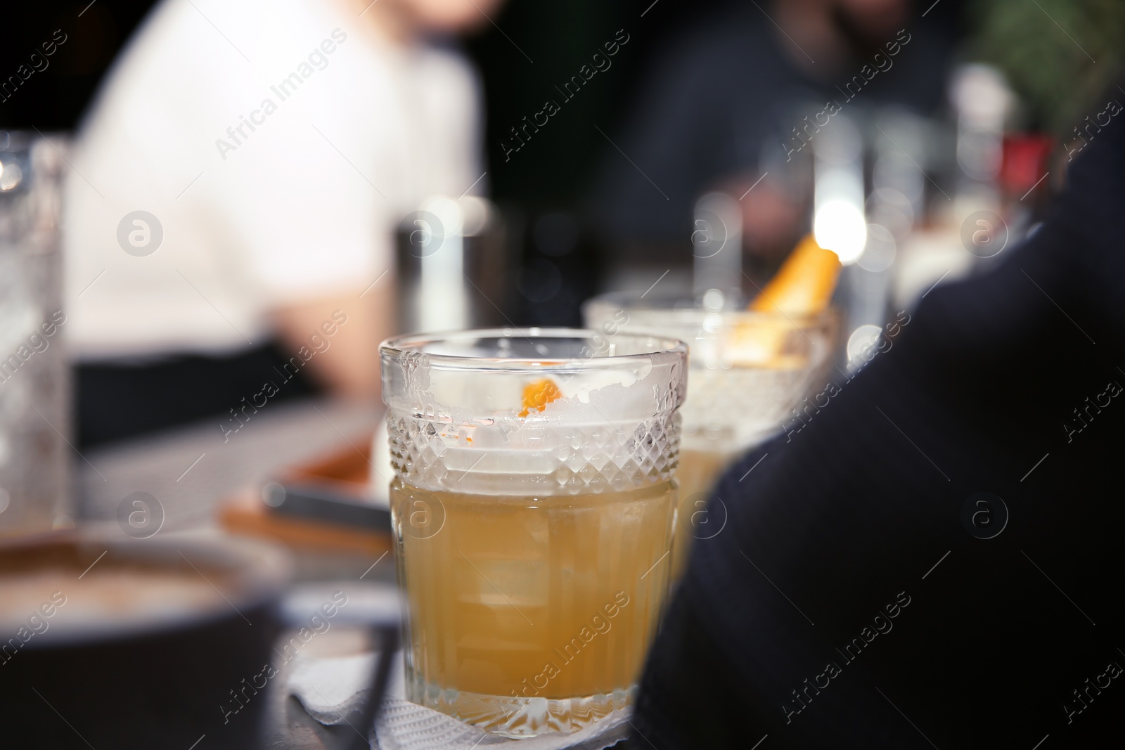 Photo of Glass of tasty cocktail on bar counter