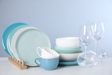 Photo of Set of clean tableware on light table