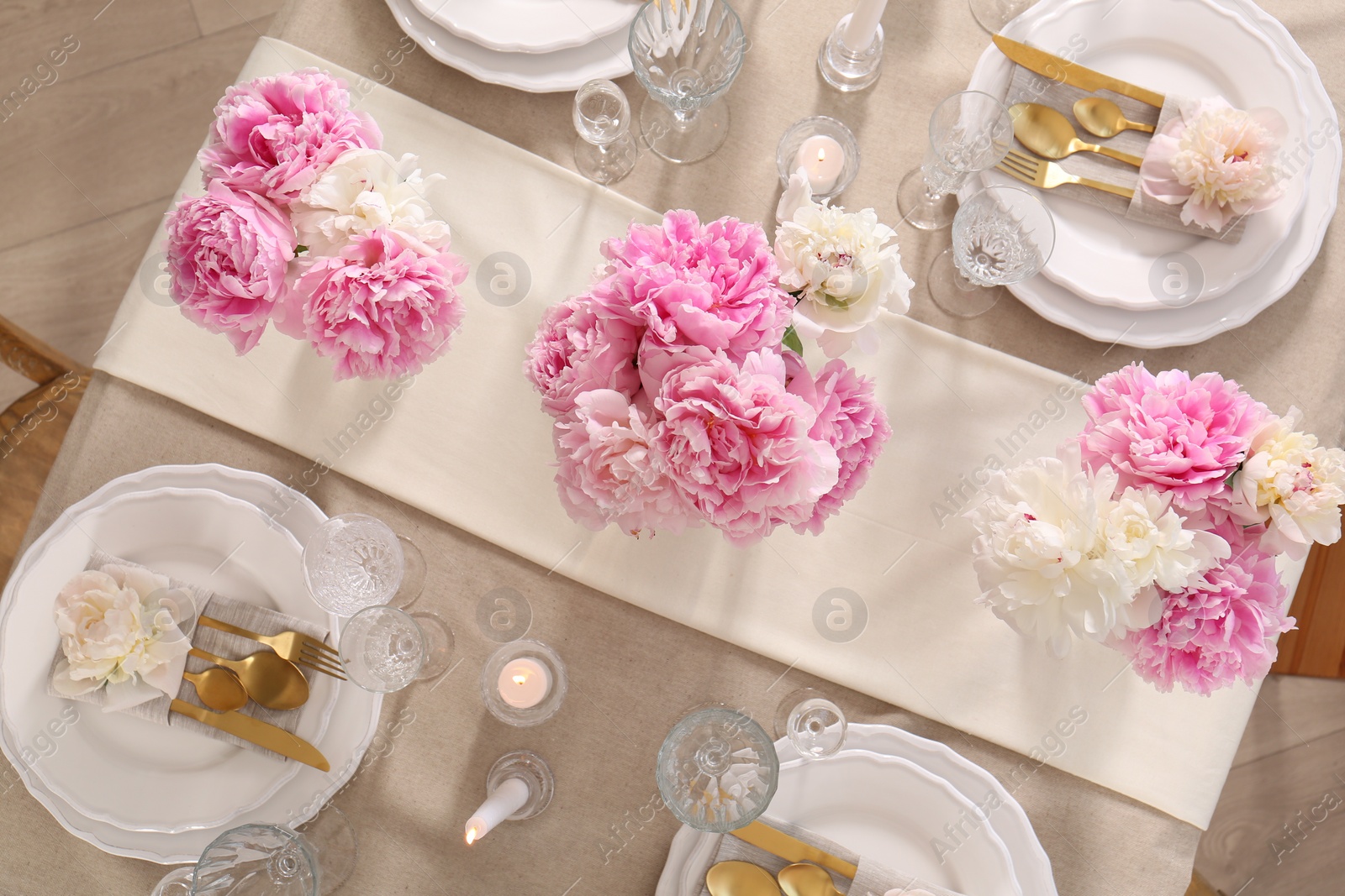 Photo of Stylish table setting with beautiful peonies and burning candles, flat lay