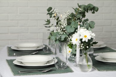 Photo of Elegant festive setting with floral decor on table