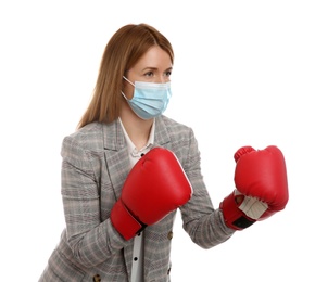 Photo of Businesswoman with protective mask and boxing gloves on white background. Strong immunity concept