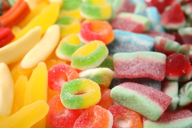 Tasty colorful jelly candies as background, closeup view