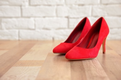 Pair of red female shoes on floor