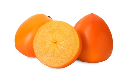 Whole and cut delicious ripe juicy persimmons on white background