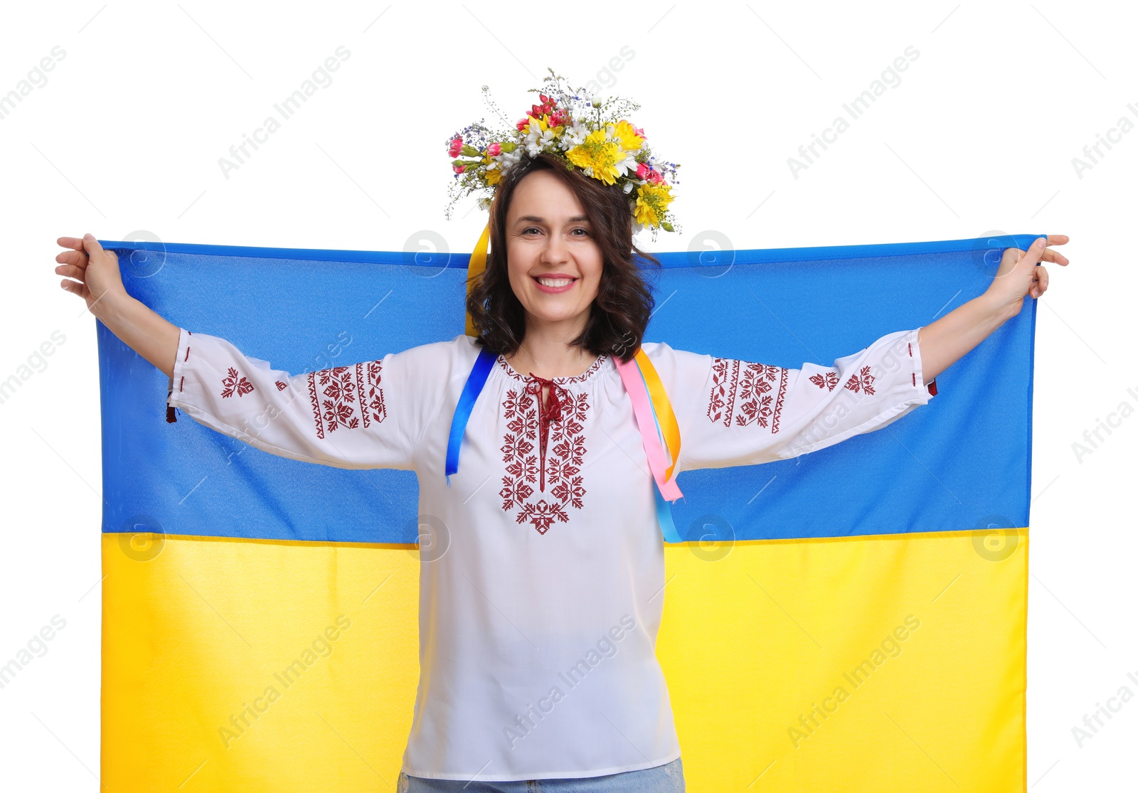 Photo of Happy woman in national clothes with flag of Ukraine on white background