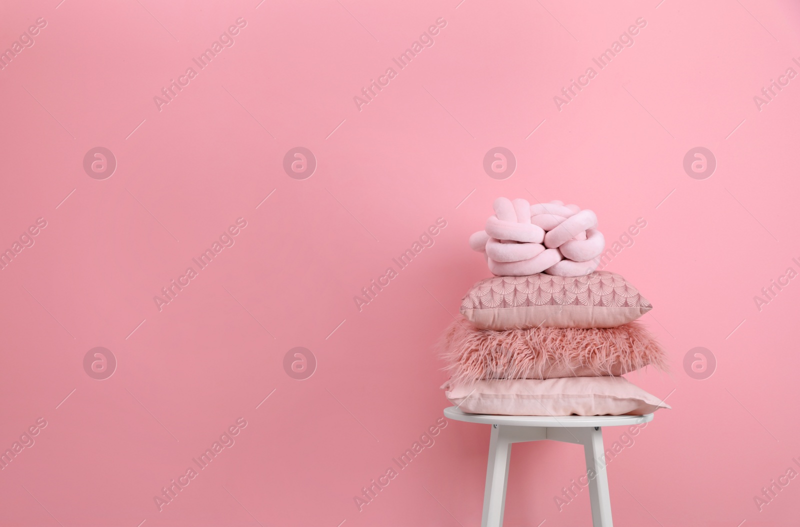 Photo of Chair with many different pillows and space for text on color background