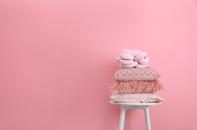 Photo of Chair with many different pillows and space for text on color background