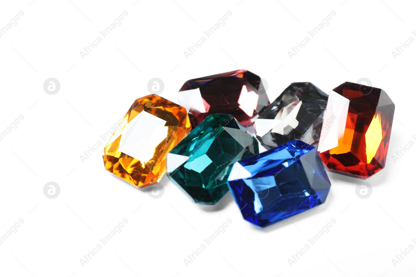 Photo of Different beautiful bright gemstones on white background