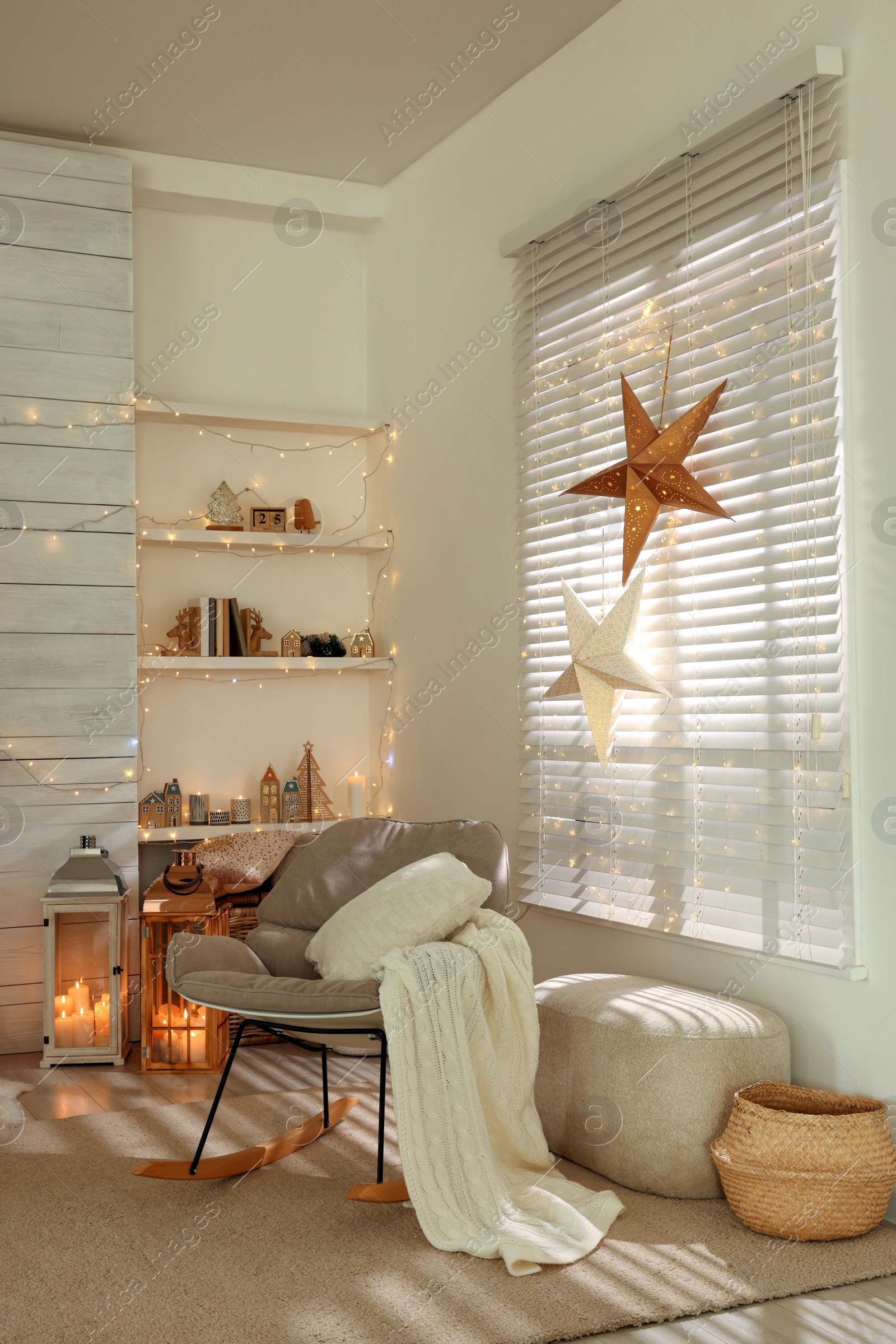 Photo of Beautiful decorative stars and festive lights in room. Christmas atmosphere