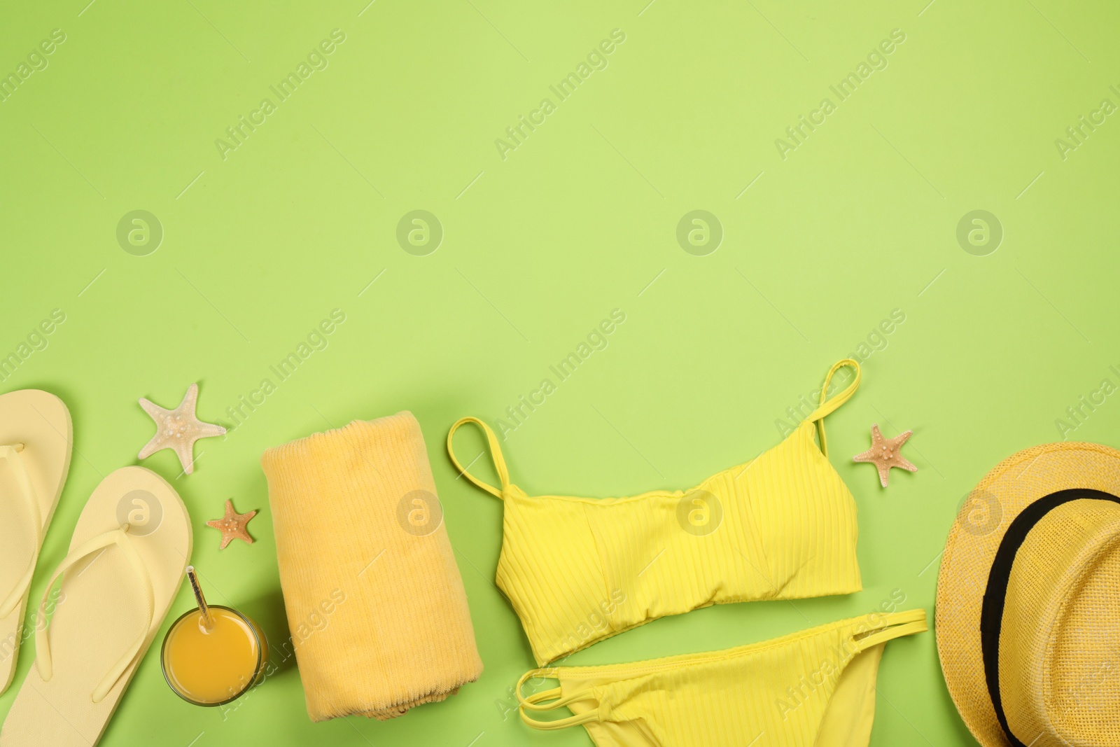 Photo of Flat lay composition with beach objects on green background, space for text