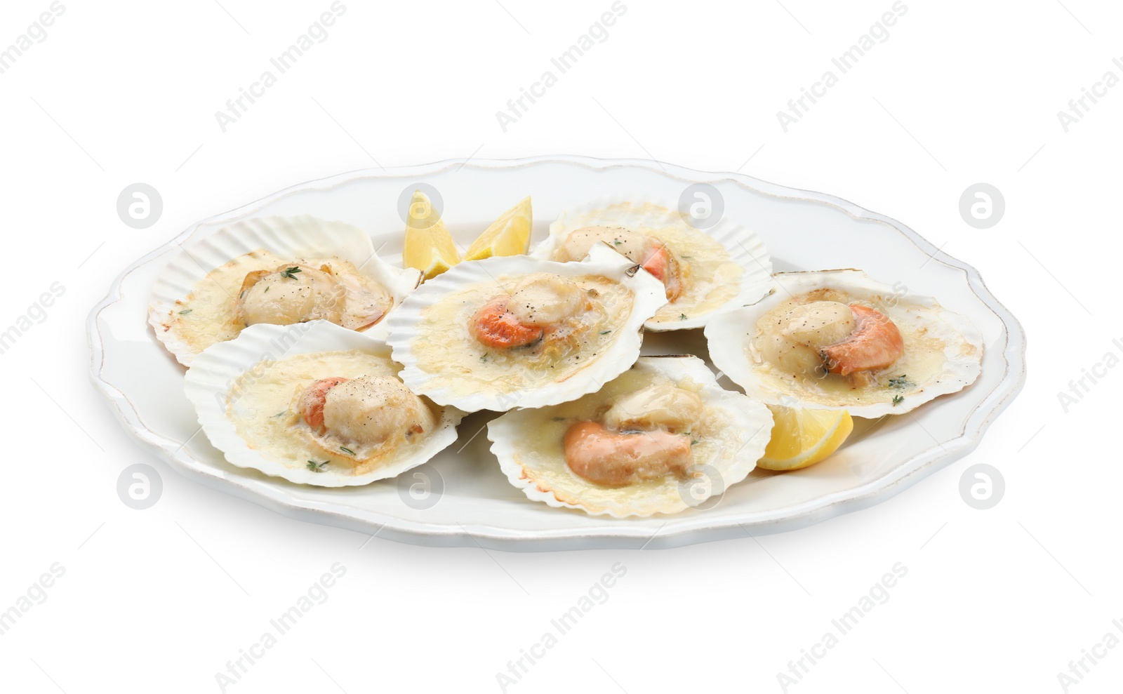 Photo of Fried scallops in shells and lemon isolated on white