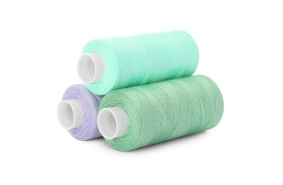 Photo of Different colorful sewing threads on white background