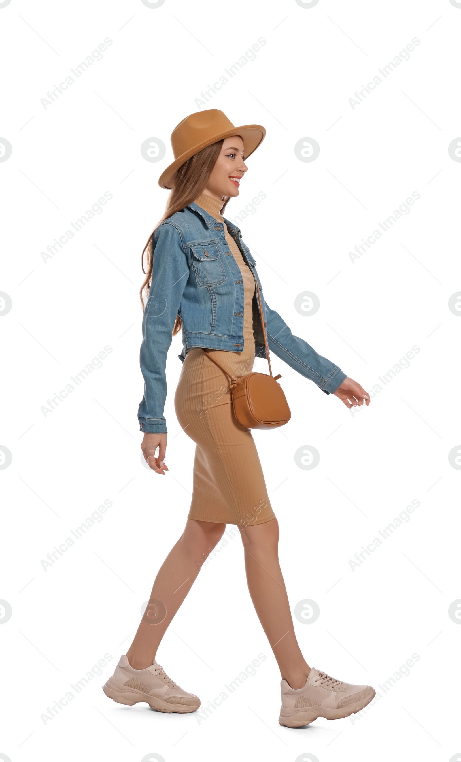 Photo of Young woman in casual outfit walking on white background