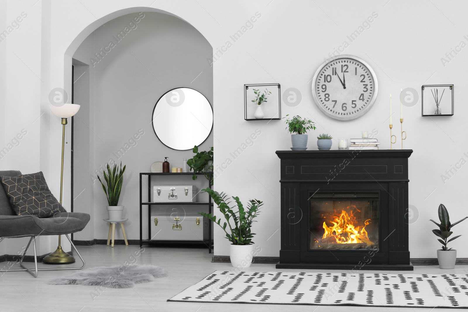 Photo of Stylish living room interior with fireplace and green plants