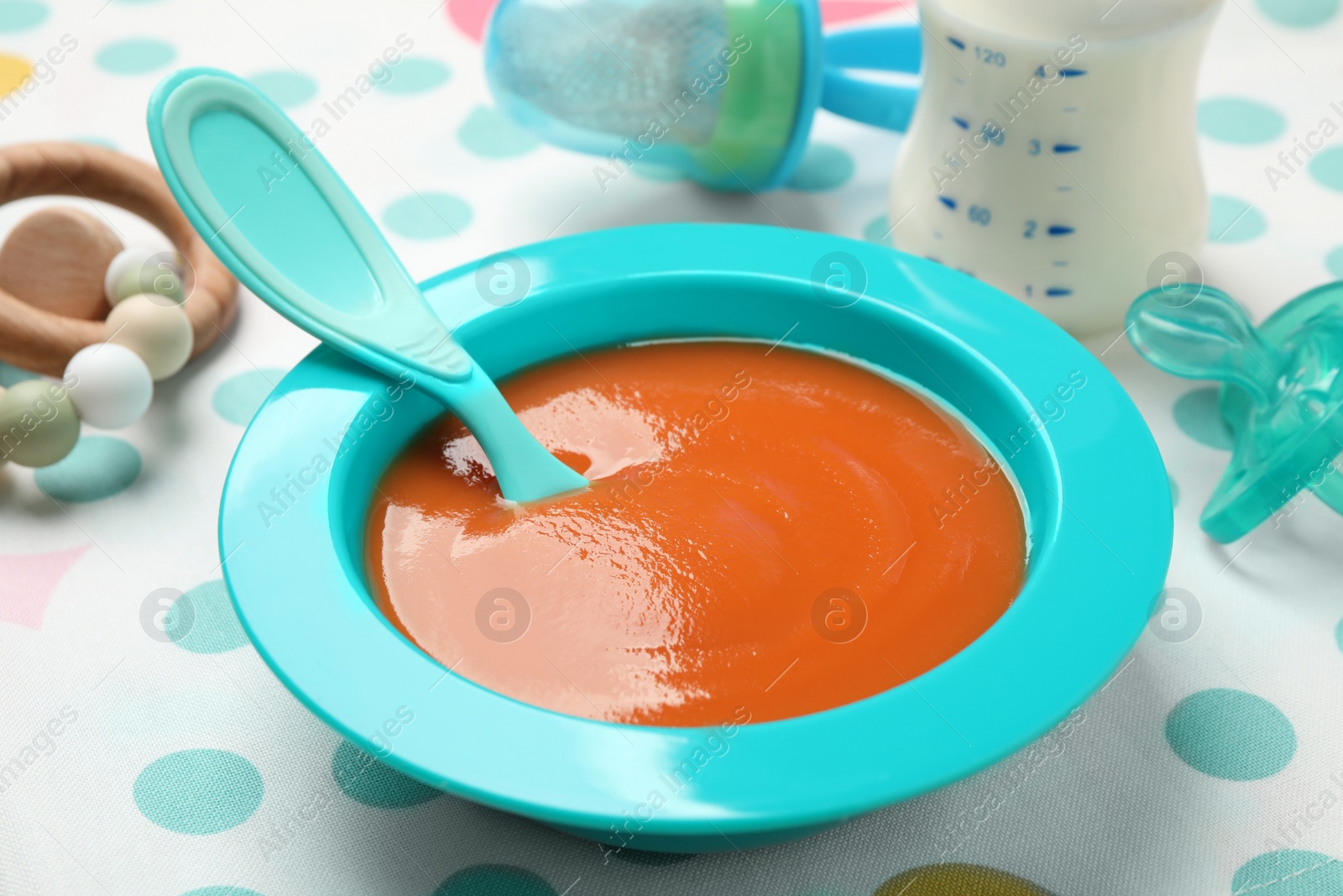 Photo of Healthy baby food in bowl on table, closeup