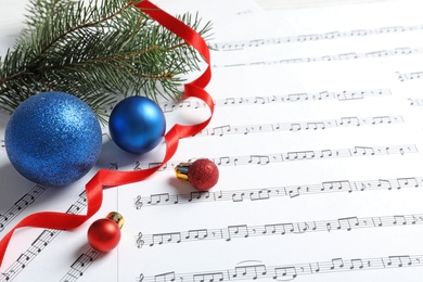 Photo of Composition with Christmas decorations on music sheets