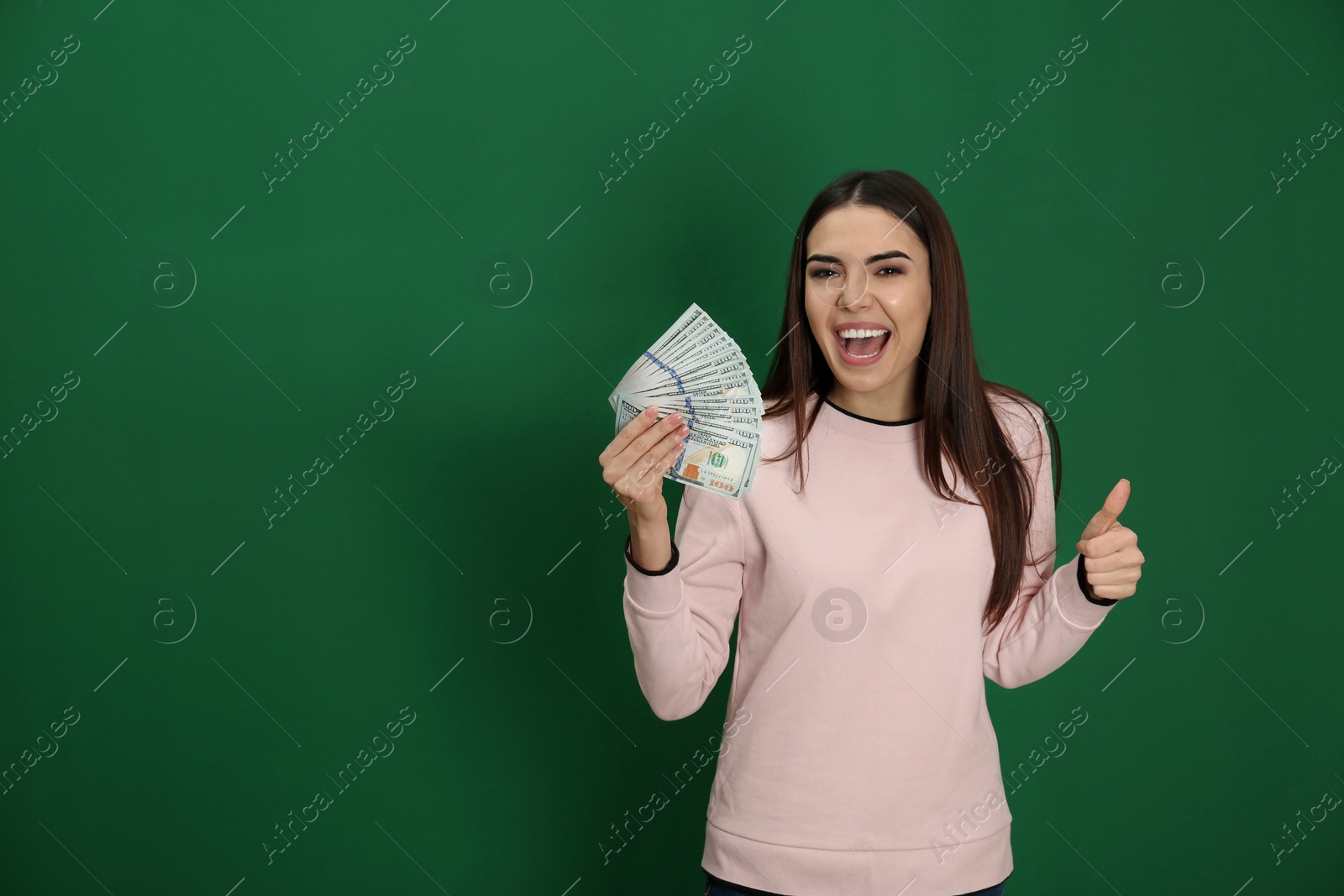 Photo of Young woman with money on color background