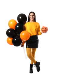 Photo of Beautiful woman with balloons and Jack O'Lantern candy container on white background. Halloween party