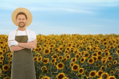 Image of Confident farmer with crossed arms in field. Harvesting season