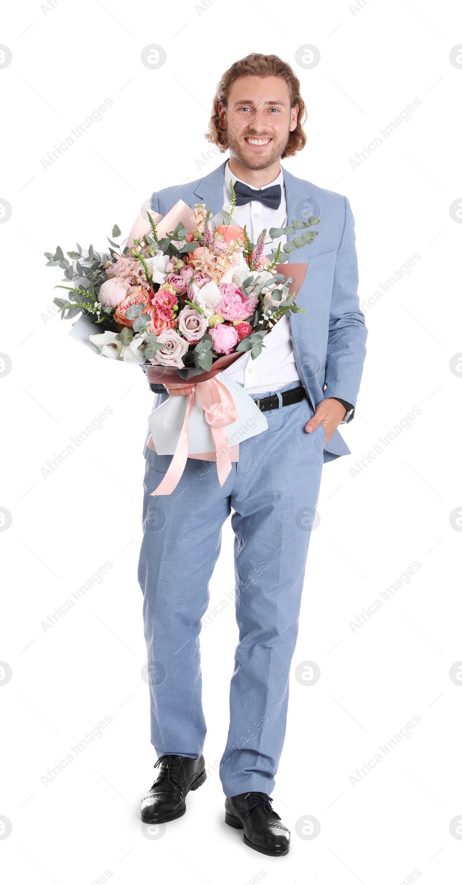 Photo of Young handsome man in stylish suit with beautiful flower bouquet on white background