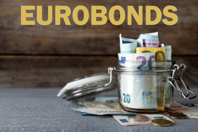 Image of Eurobonds concept. Glass jar full of money on wooden table
