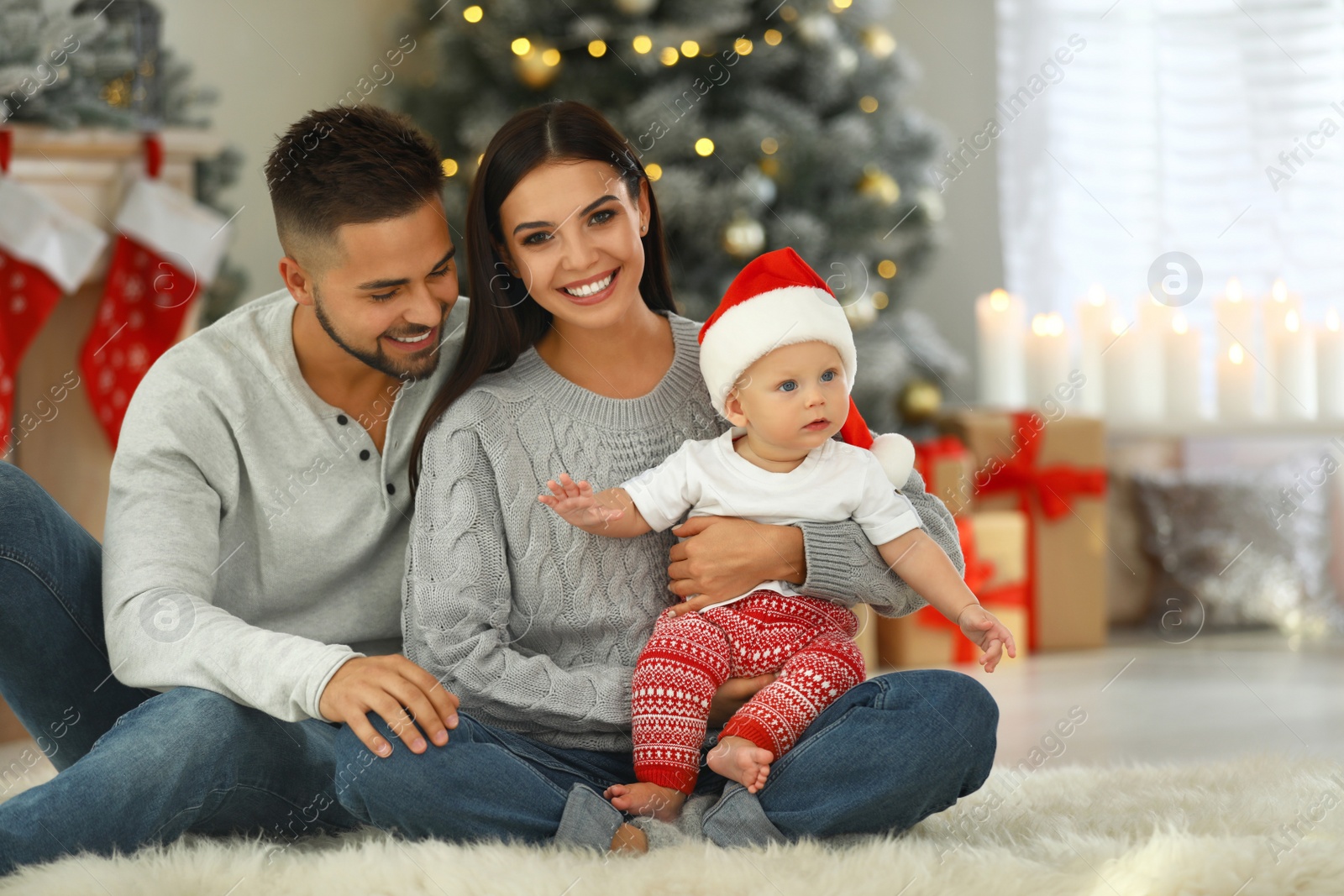 Photo of Happy family with cute baby at home. Christmas celebration