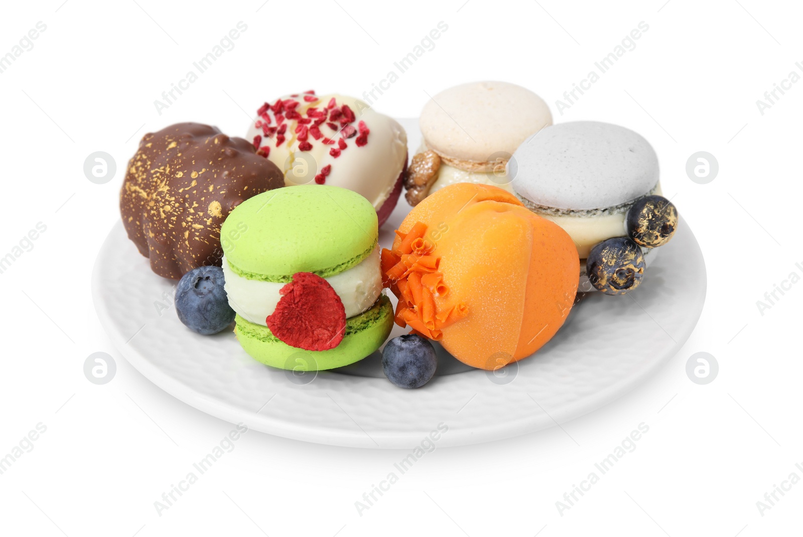 Photo of Plate with delicious macarons and blueberries isolated on white
