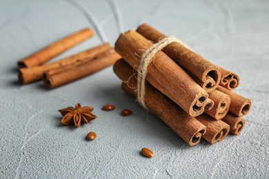 Photo of Tied cinnamon sticks on light background