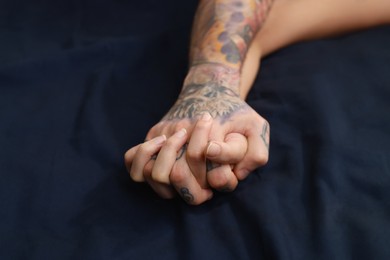 Passionate couple having sex on bed, closeup of hands