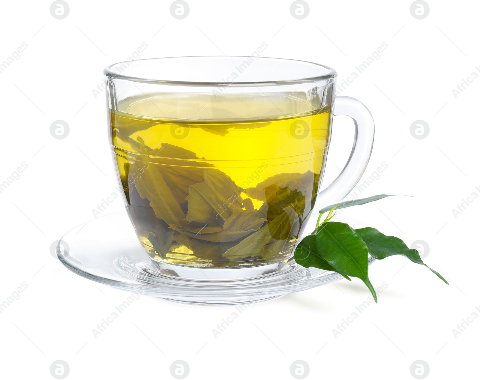 Photo of Fresh green tea in glass cup, leaves and saucer isolated on white