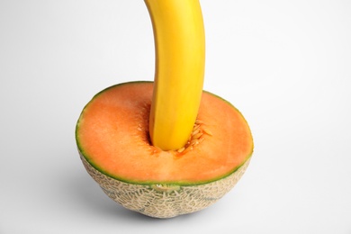 Photo of Fresh banana and melon on white background. Sex concept