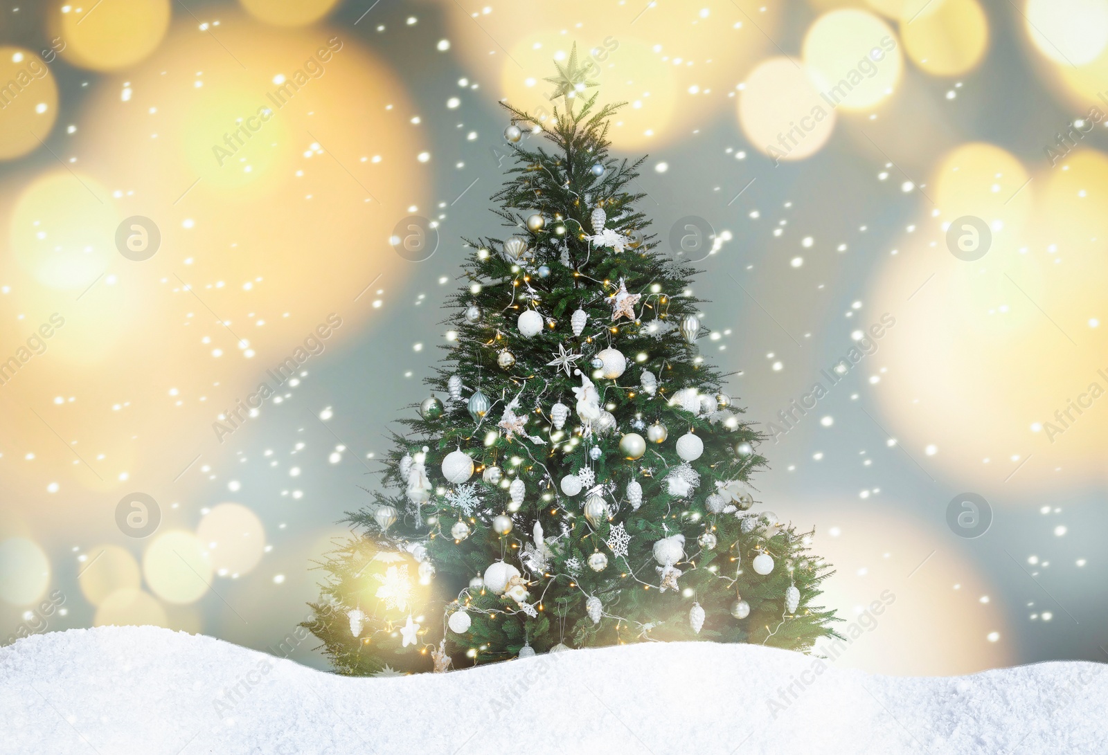 Image of Beautifully decorated Christmas tree and snow on light background. Bokeh effect