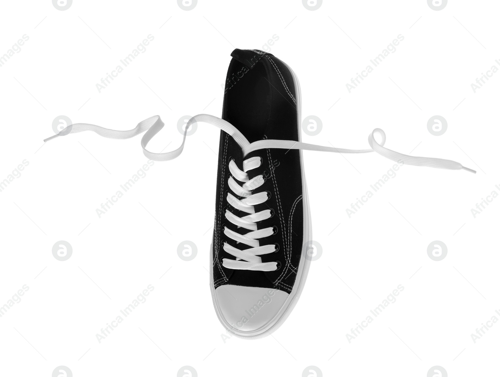 Photo of One black classic old school sneaker isolated on white