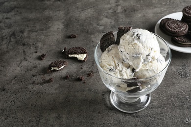Photo of Bowl of chocolate cookies ice cream on table. Space for text