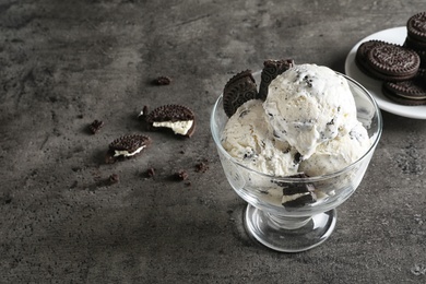 Bowl of chocolate cookies ice cream on table. Space for text