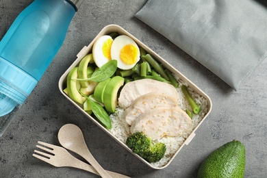 Photo of Flat lay composition with container of natural protein food on gray background