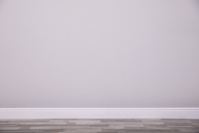 Photo of Blank light grey wall in room. Space for design