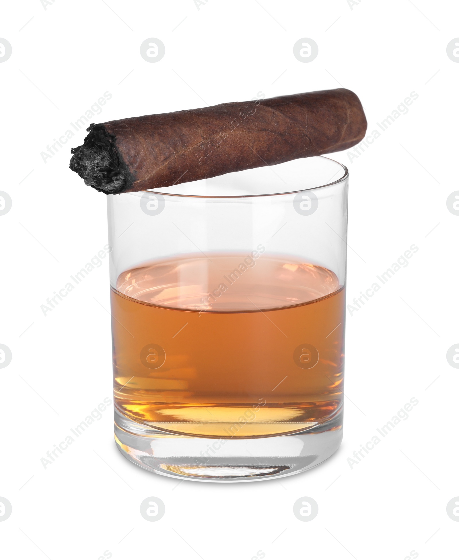 Photo of Glass of whiskey and burnt cigar isolated on white